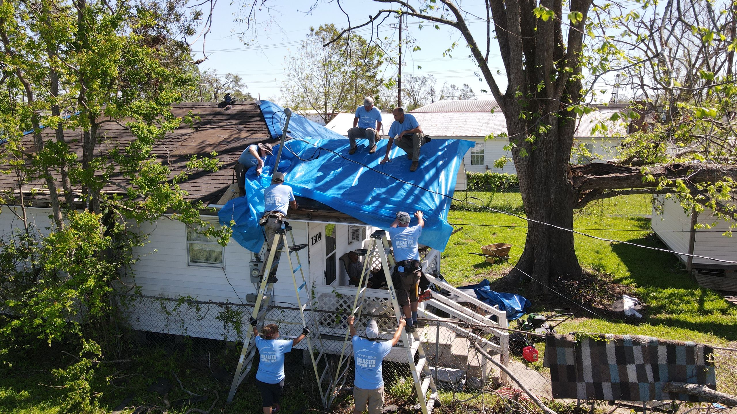 Hope Force Reservists tarping a roof
