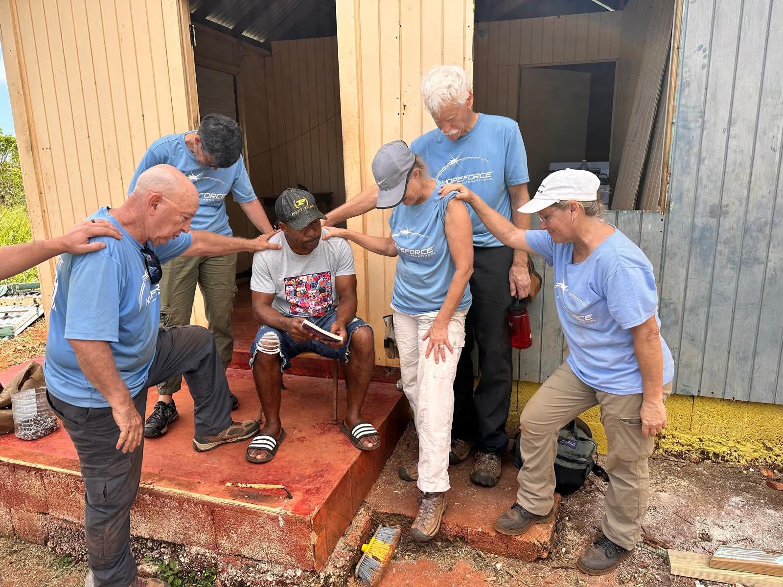 Hope Force team praying over a hurricane survivor.